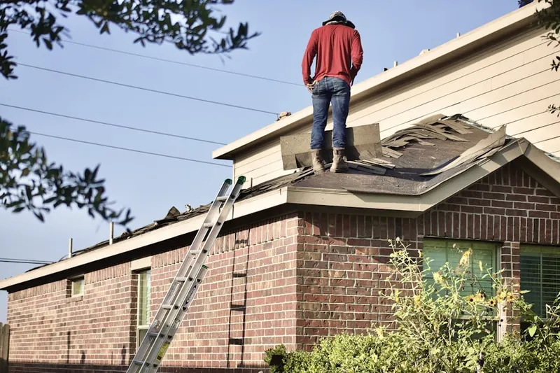 Professional roofer working on a residential roof in Three Lakes